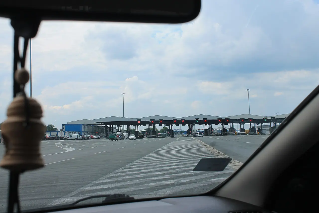 The row of border booths at Batrovci seen through a car windscreen on a cloudy afternoon