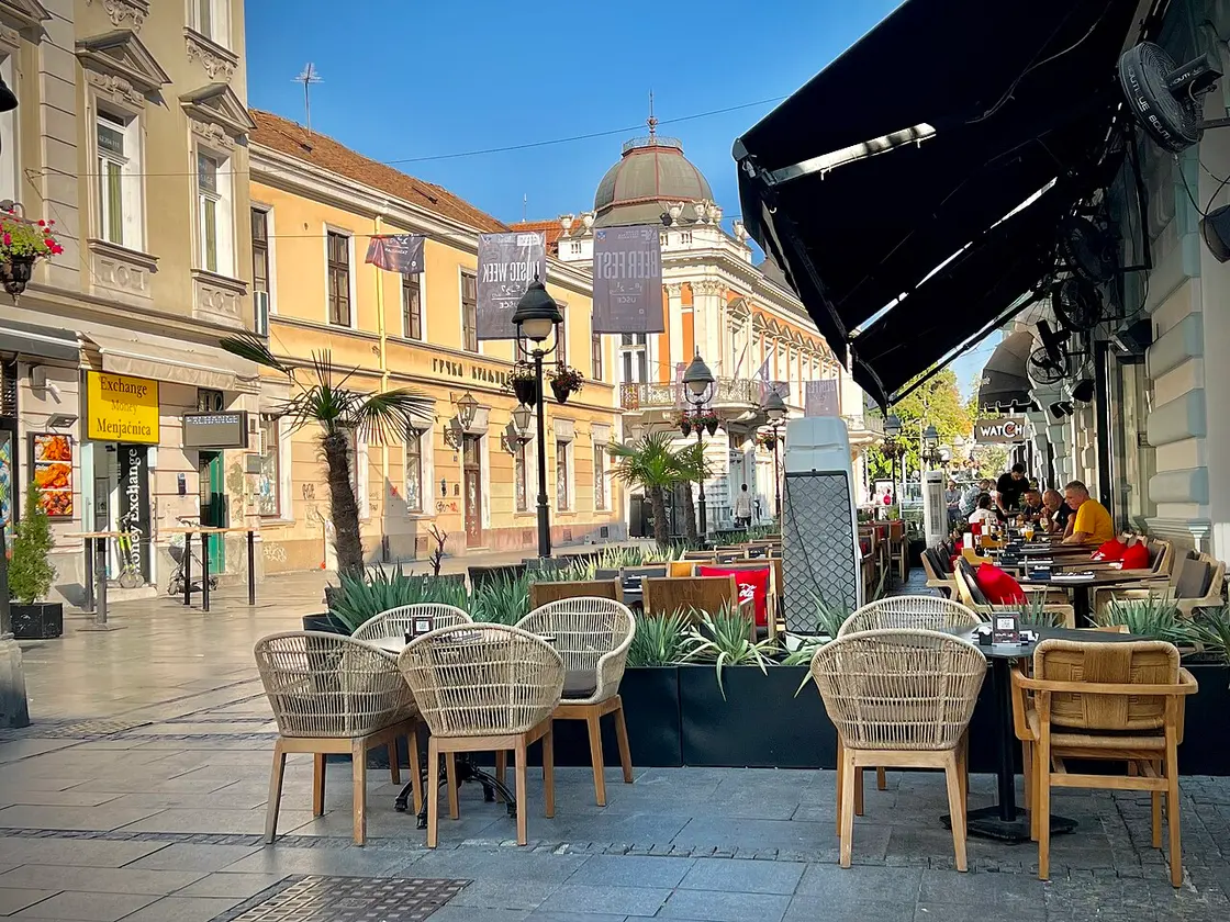 Outdoor cafe seating on a Belgrade street corner on a summer day