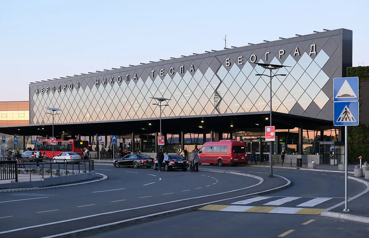 The main terminal building of Belgrade Nikola Tesla Airport under a clear sky