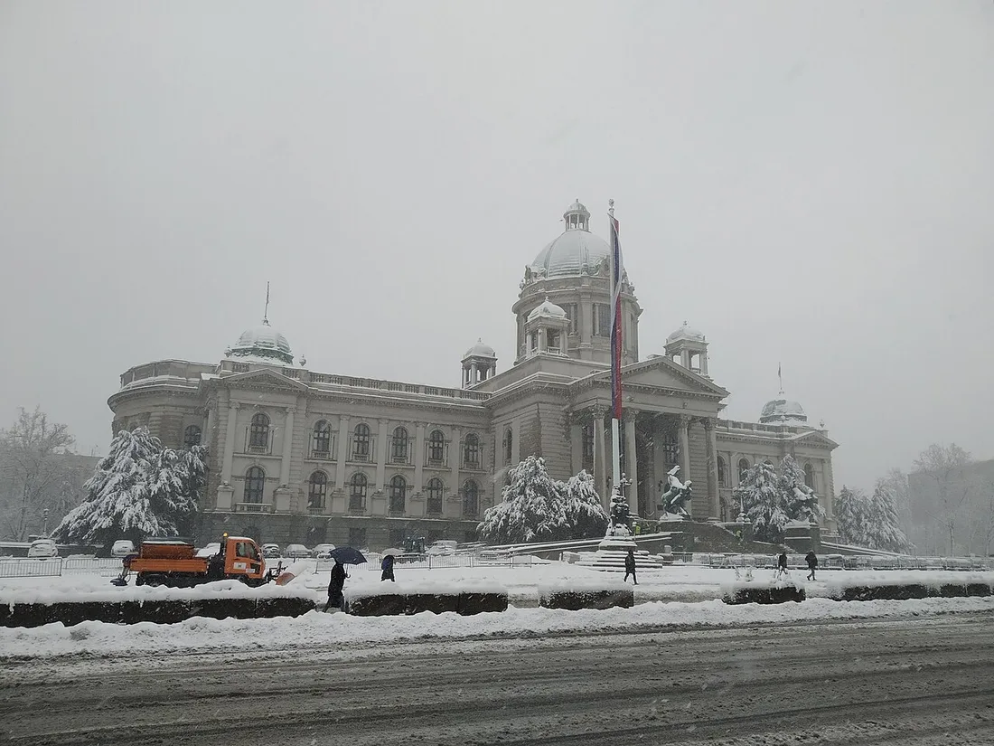 The National Assembly building in Belgrade under a covering of snow on a grey winter day