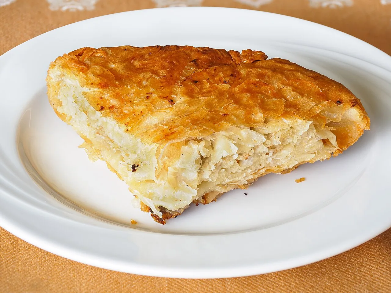 A coil of meat burek, golden filo pastry filled with minced meat, from a Belgrade bakery