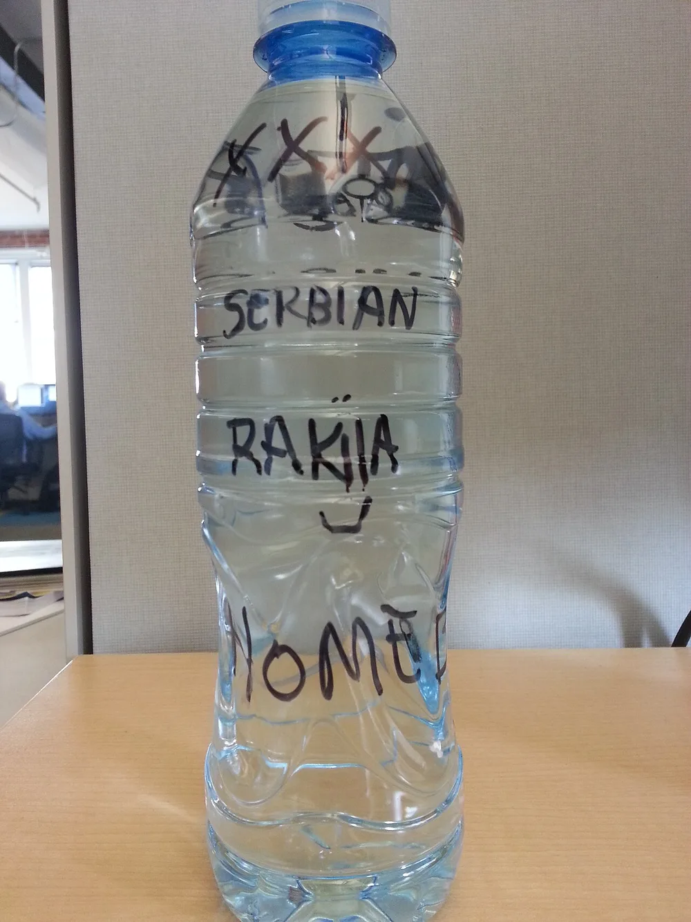 A bottle and small glasses of homemade Serbian rakija fruit brandy