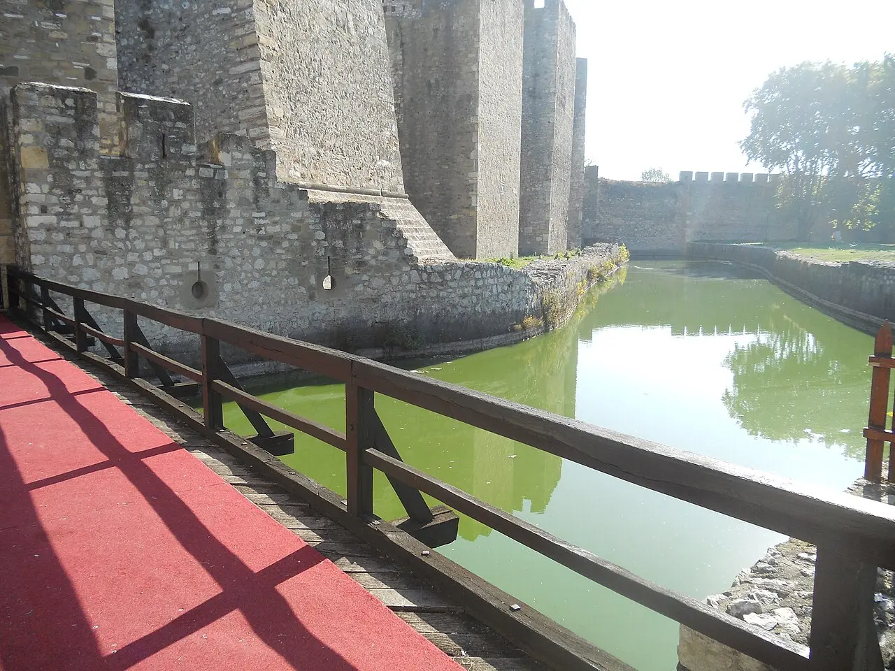 Square medieval towers and curtain walls inside Smederevo Fortress under a bright sky