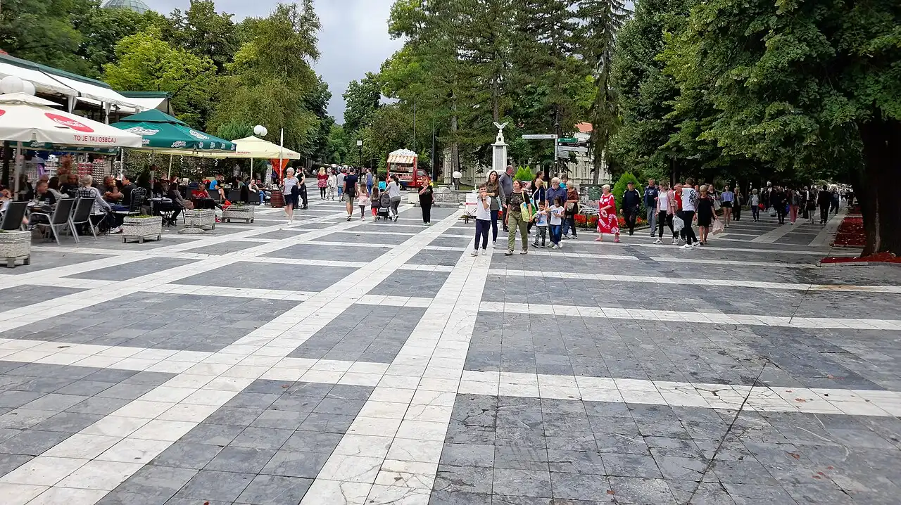 Tree-lined paths through the central city park in Sokobanja on a clear day