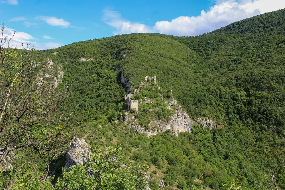 Ruined stone towers of the medieval Sokograd fortress above the Moravica canyon