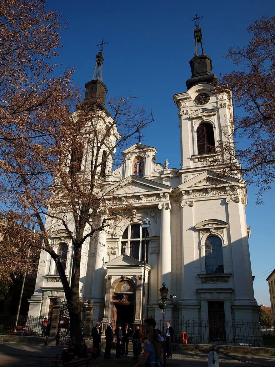 The white Baroque Orthodox cathedral of Sremski Karlovci with its twin towers seen from the street