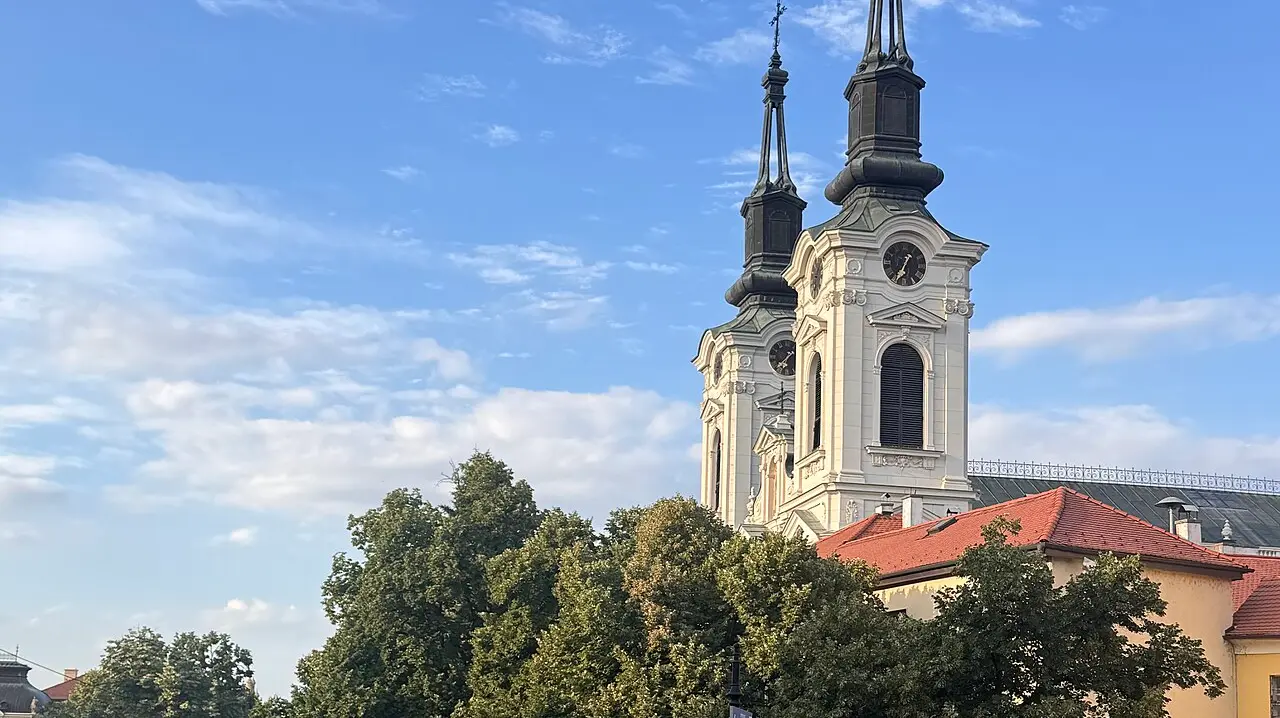 The main square of Sremski Karlovci with the twin towers of the Orthodox cathedral above the trees