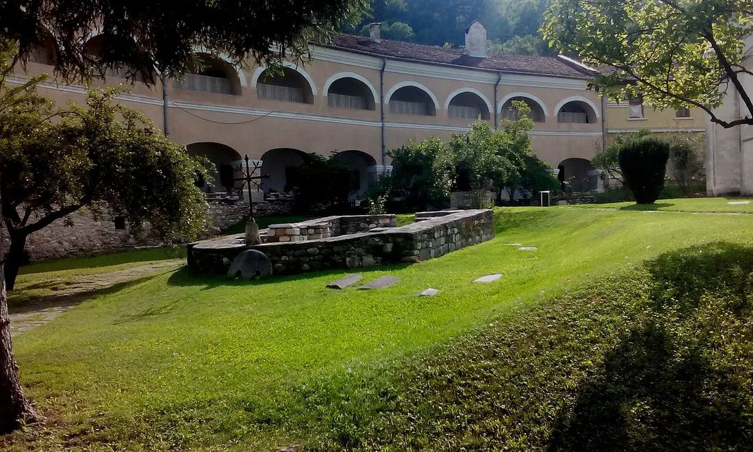 The arcaded monastery lodging and green grounds inside the walls of Studenica Monastery