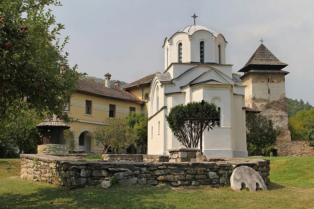 The small white King's Church at Studenica, dedicated to Saints Joachim and Anna, with the monastery lodging and an old tower behind