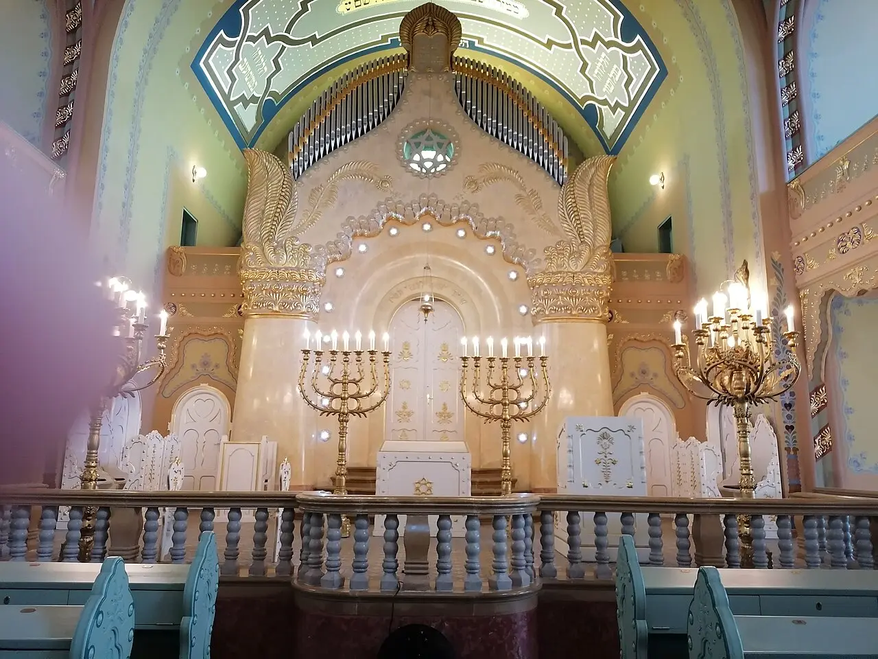The restored interior of the Subotica synagogue with its painted dome, organ and candelabra