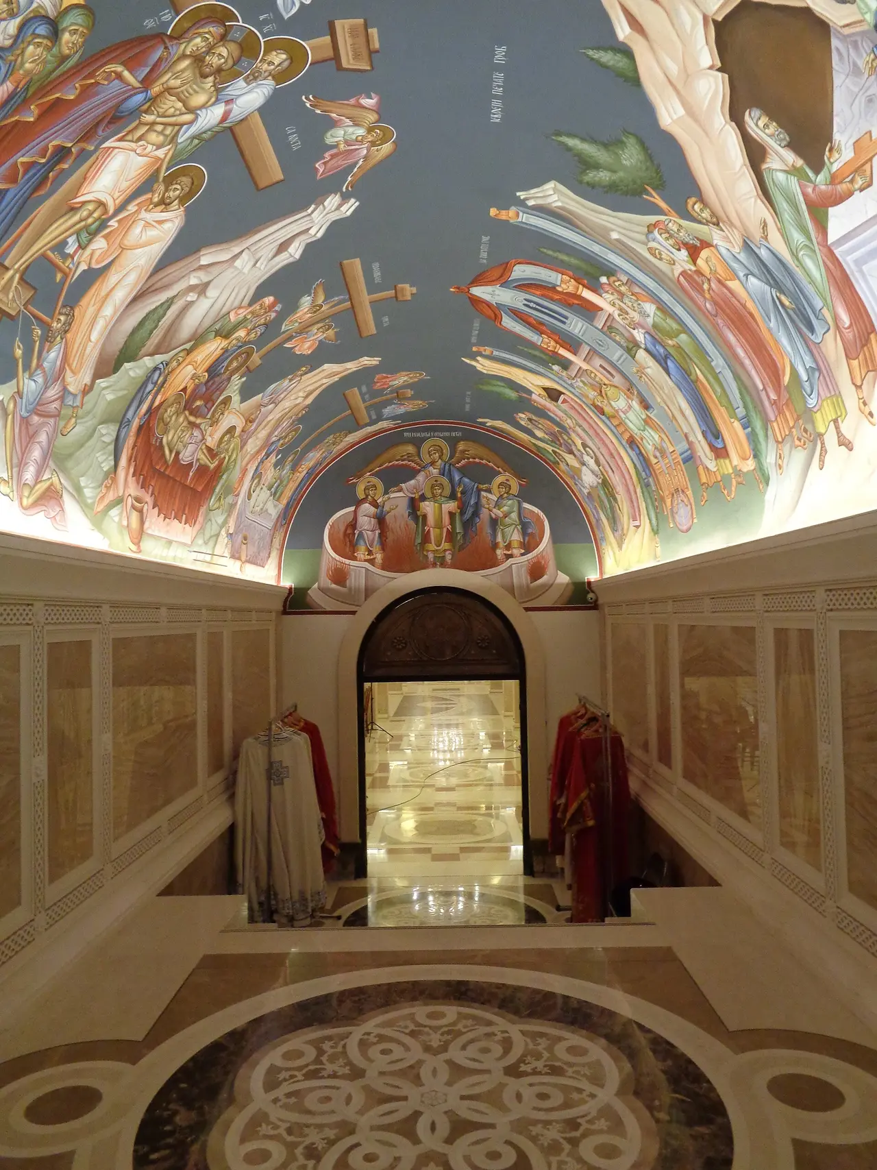 The richly gilded and frescoed crypt beneath the Temple of Saint Sava, glowing with gold mosaic and painted arches