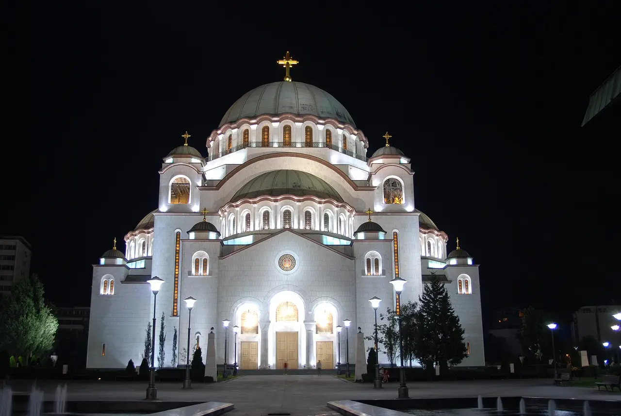 The Temple of Saint Sava floodlit white against the night sky above Belgrade