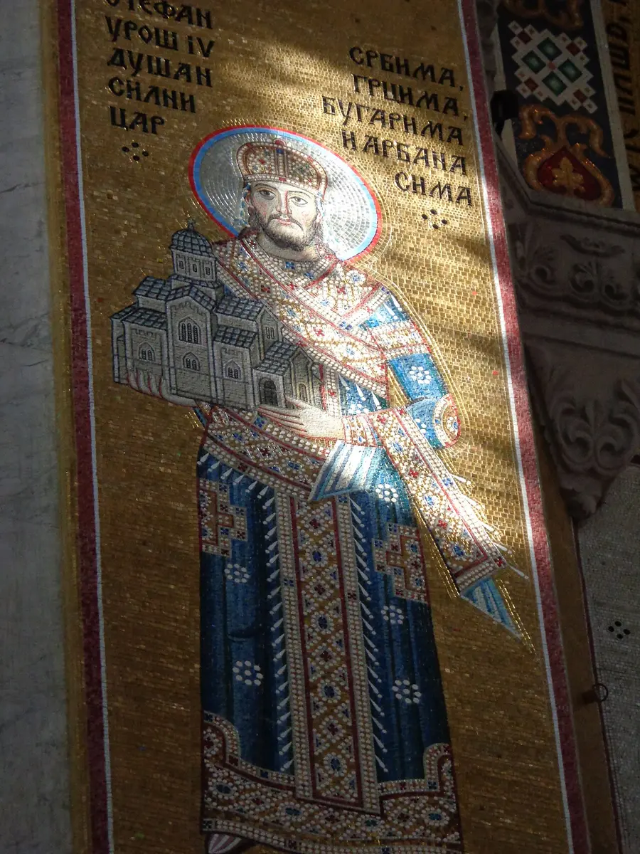 A gold-ground mosaic inside the Church of Saint Sava depicting Emperor Dušan holding a model of the church