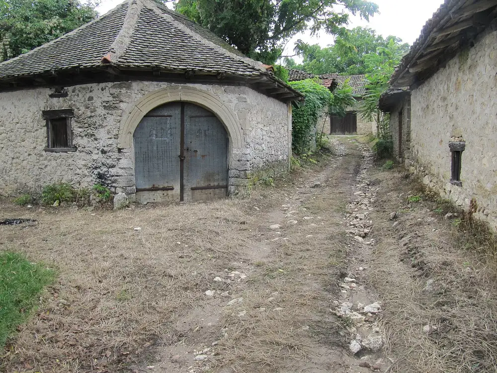 A lane of 18th and 19th century stone wine cellars with an arched stone doorway at Rajačke pimnice
