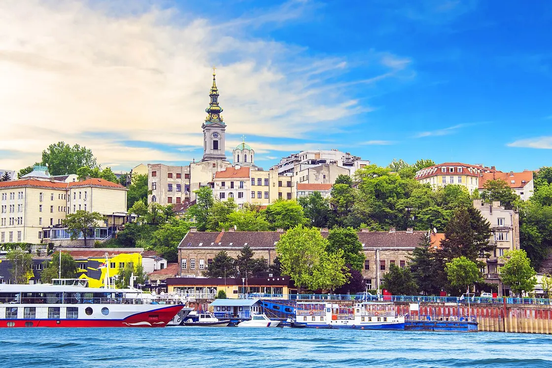 A wide view over the rooftops and modern towers of central Belgrade on a bright day
