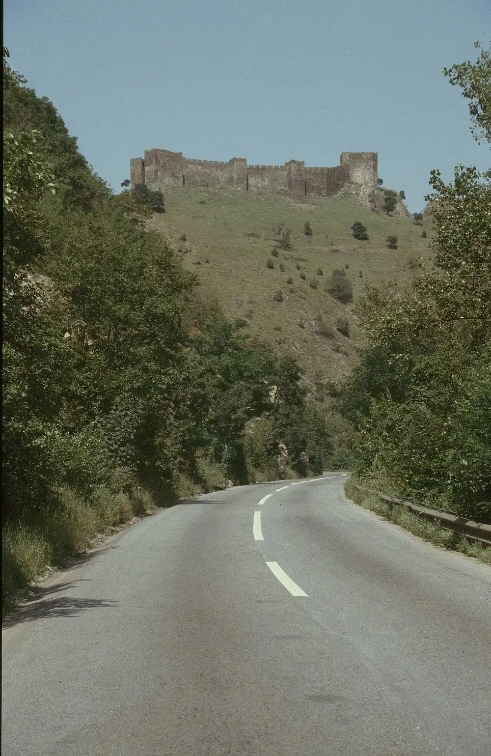 Maglic fortress crowning a green hill above the Ibar valley road