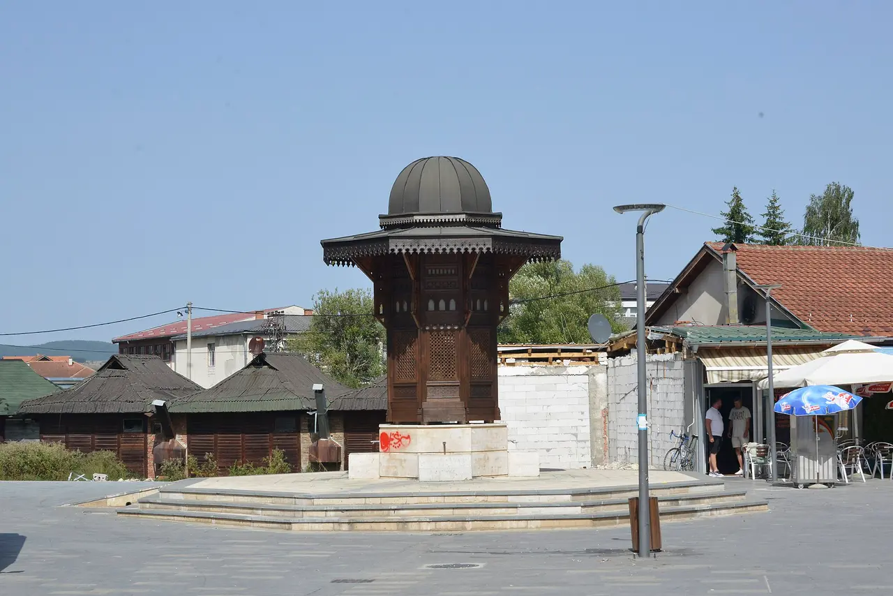 An Ottoman-style sebil drinking fountain with a wide eaved roof on a square in Sjenica