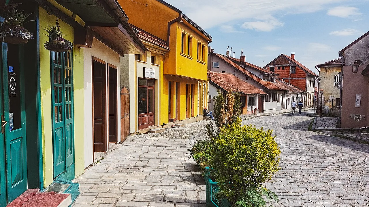 A cobbled street in the Tesnjar old quarter of Valjevo lined with colourful low 19th-century craft houses