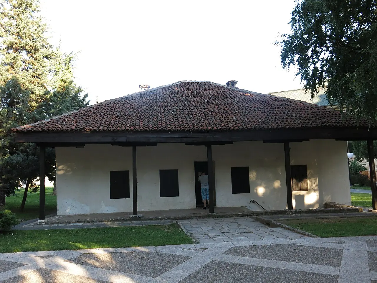 The whitewashed exterior of Muselim's Residence in Valjevo with a wide tiled roof and wooden eaves