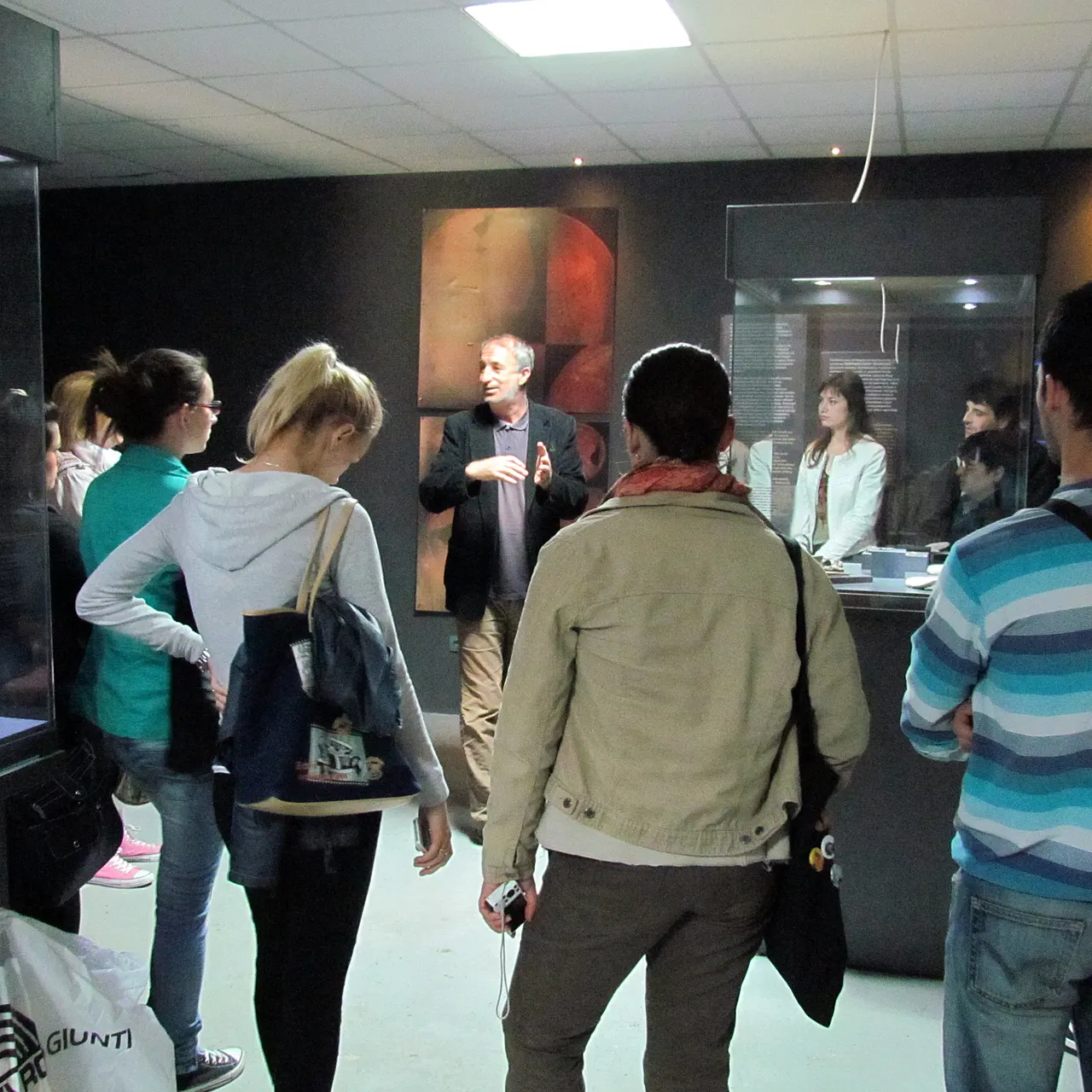 Curator Dragan Jankovic leading a small group of visitors through the exhibition room at the Vinca archaeological site