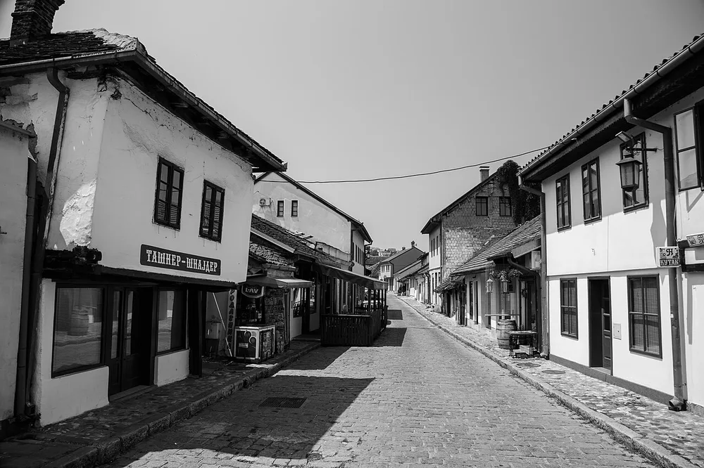 The cobbled main street of the old Tesnjar craft quarter in Valjevo, lined with low 19th-century houses and workshops