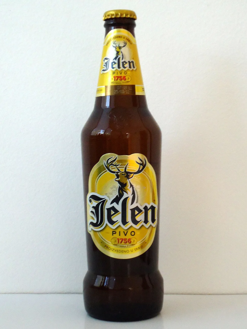 A bottle of Jelen Pivo, the Serbian pale lager, with its gold deer-logo label
