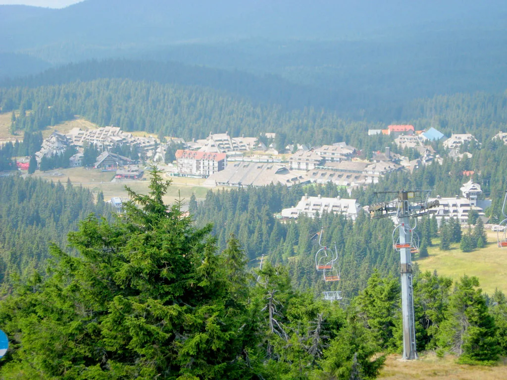 The whole Kopaonik resort village seen from the slopes in summer with a chairlift in the foreground