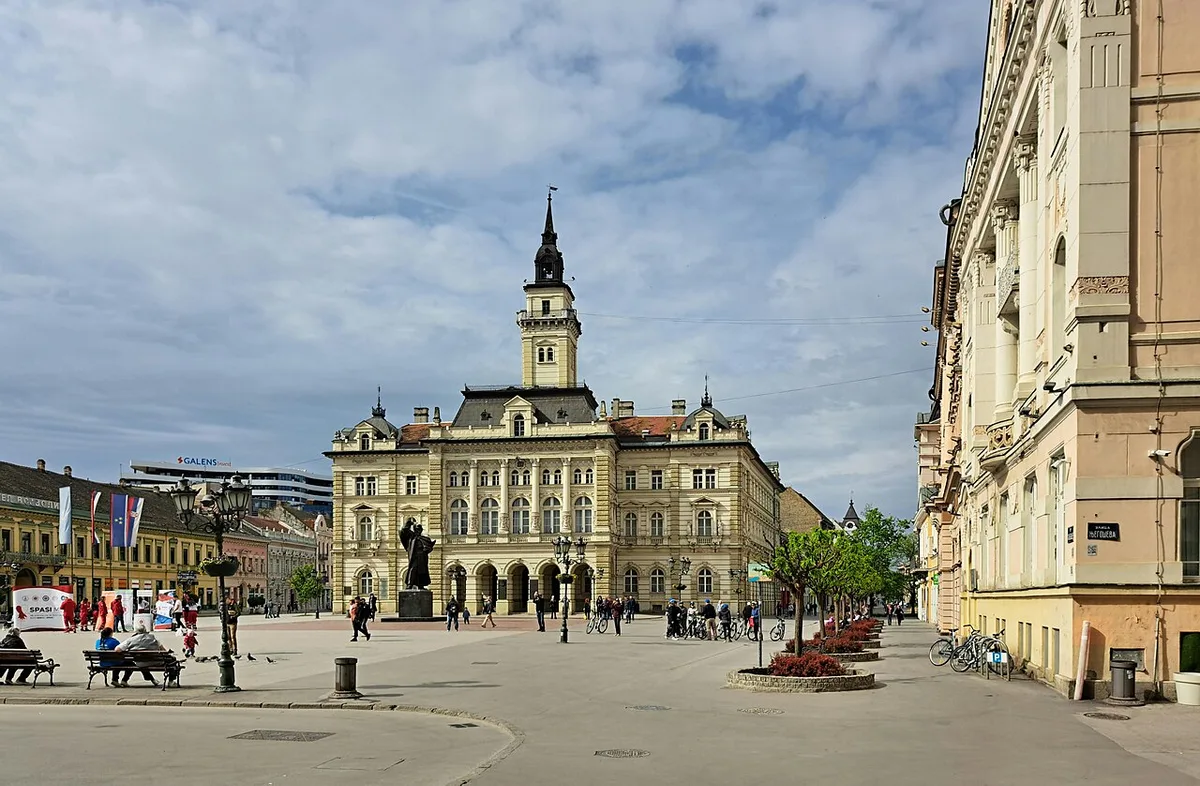 Freedom Square in central Novi Sad with the City Hall tower and pastel old-town buildings opening onto the pedestrian streets