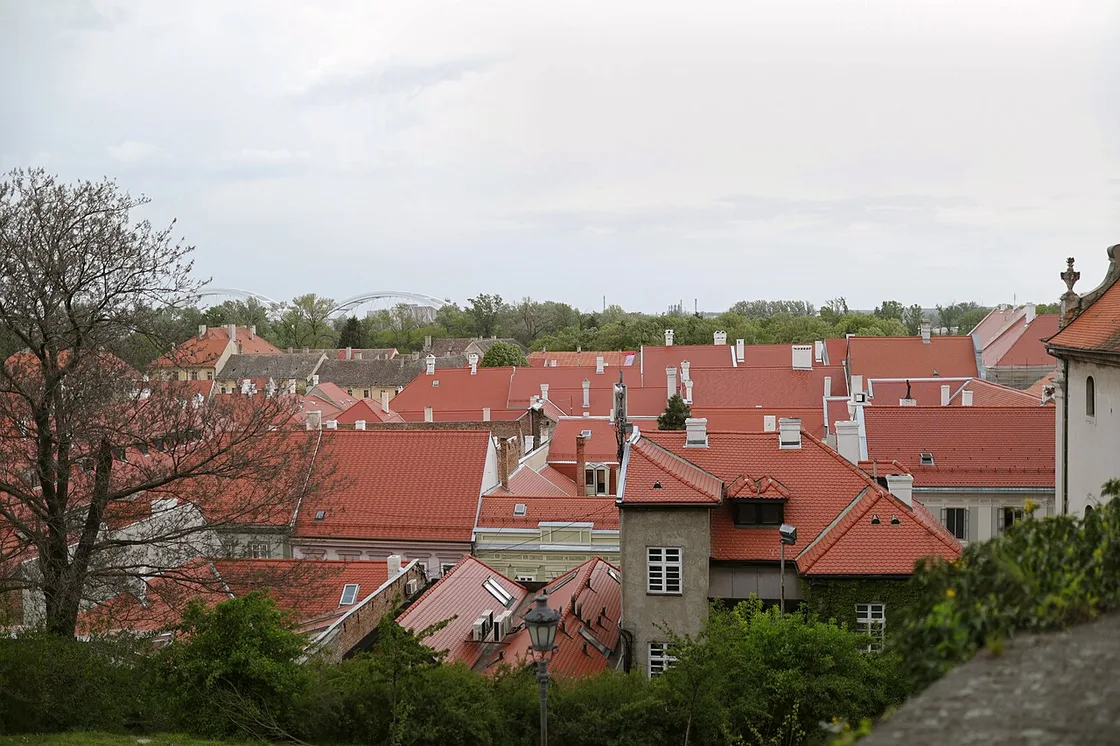 The red-tiled roofs of Petrovaradin town below the fortress, with the Danube bridges in the distance
