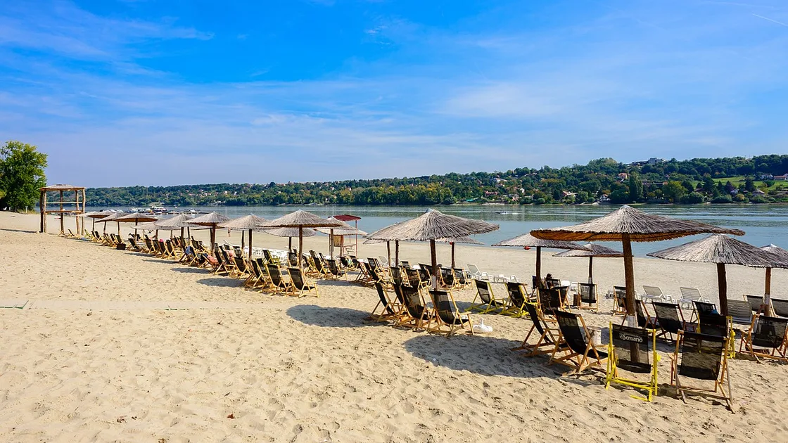 Parasols and deckchairs on the sandy Štrand beach beside the Danube at the edge of Liman in Novi Sad