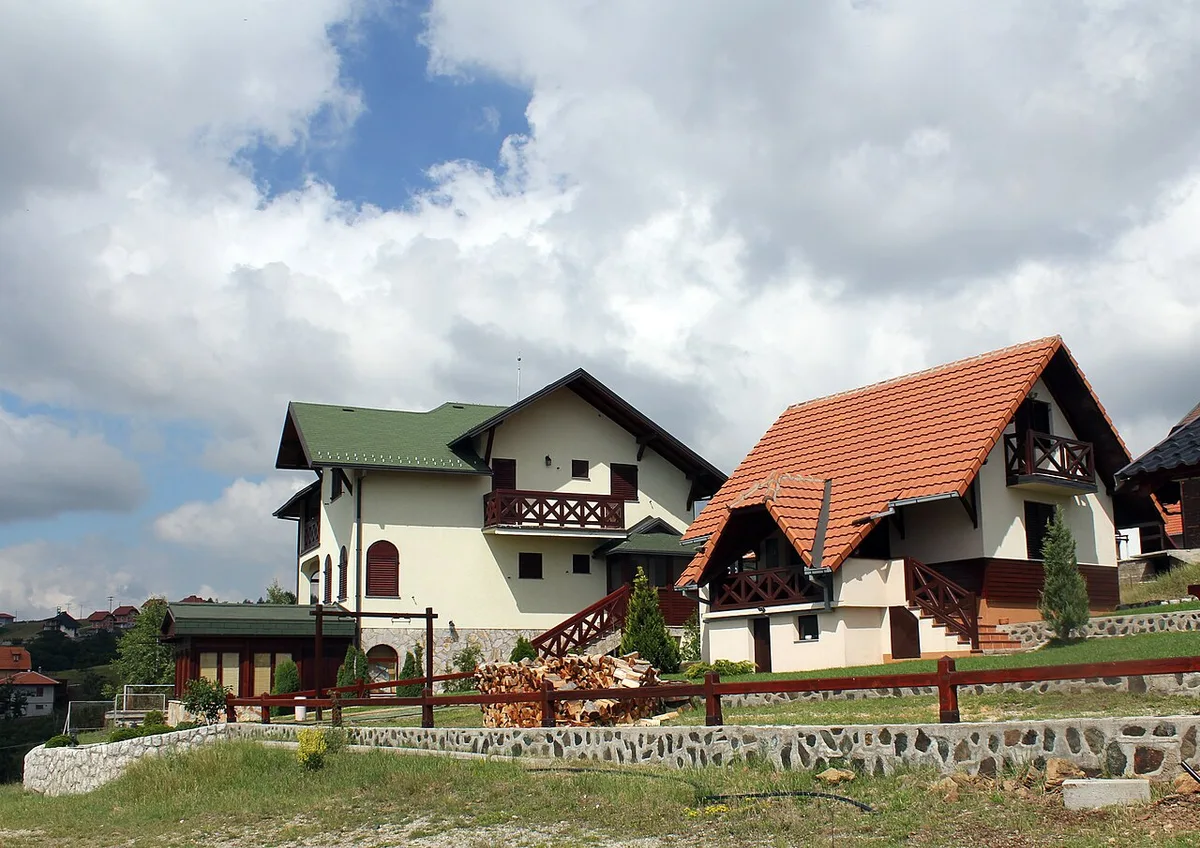 Holiday houses scattered across the open meadows and pine woods of the Zlatibor plateau