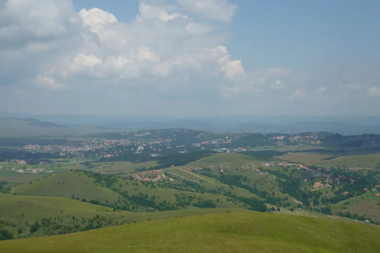 A wide view over the rounded, forested hills and meadows of the Zlatibor plateau