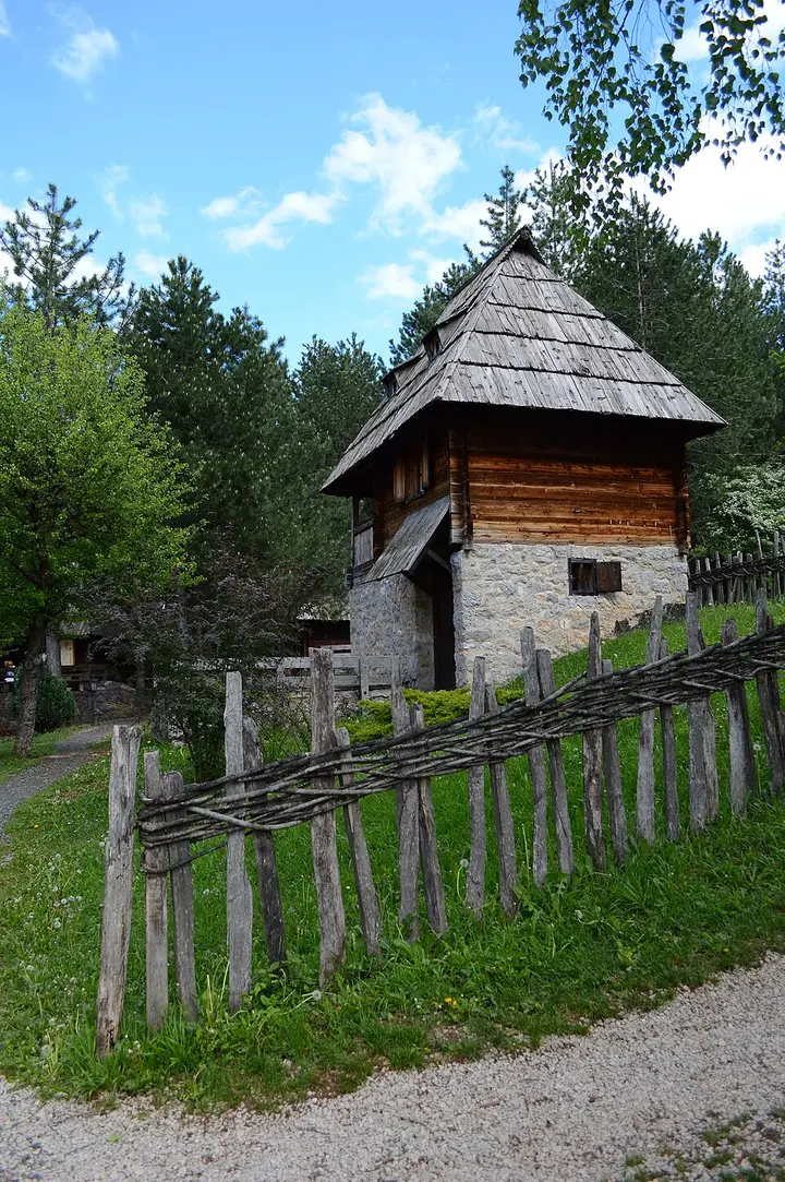 Traditional wooden houses with steep shingled roofs at the Old Village open-air museum in Sirogojno
